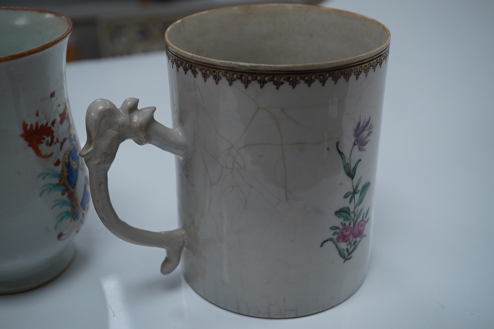 Three 18th century Chinese export armorial mugs, largest 14cm high. Condition - all restored